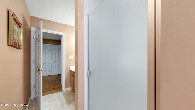 bathroom with vanity, a textured ceiling, and hardwood / wood-style flooring