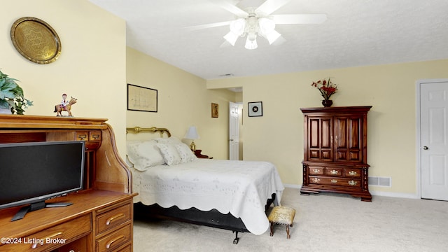 bedroom with ceiling fan and light carpet