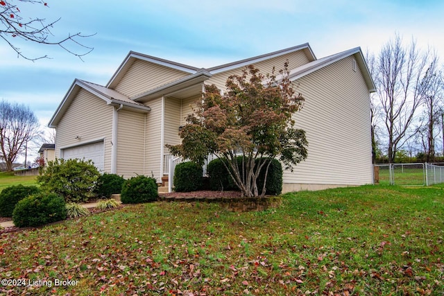 view of property exterior with a garage and a yard