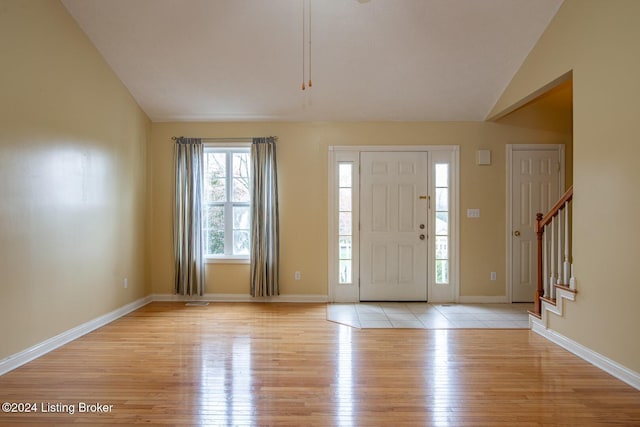 entryway featuring light hardwood / wood-style flooring and lofted ceiling