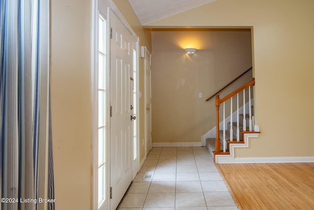 entryway featuring light hardwood / wood-style flooring and lofted ceiling