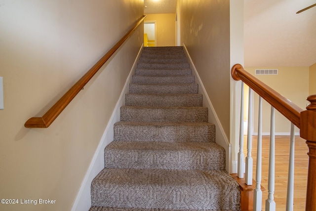 staircase with wood-type flooring