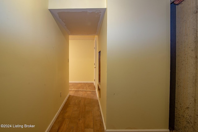 hall with hardwood / wood-style flooring