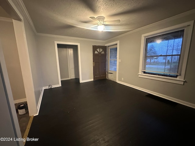 empty room with ceiling fan, crown molding, a textured ceiling, and dark wood-type flooring