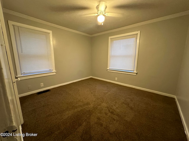 carpeted empty room with ceiling fan and crown molding