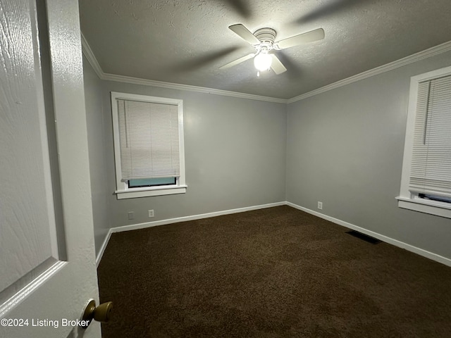 carpeted empty room featuring ceiling fan, a textured ceiling, and ornamental molding