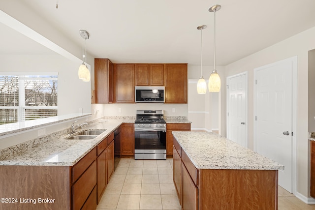 kitchen with black dishwasher, sink, decorative light fixtures, and stainless steel range with gas stovetop