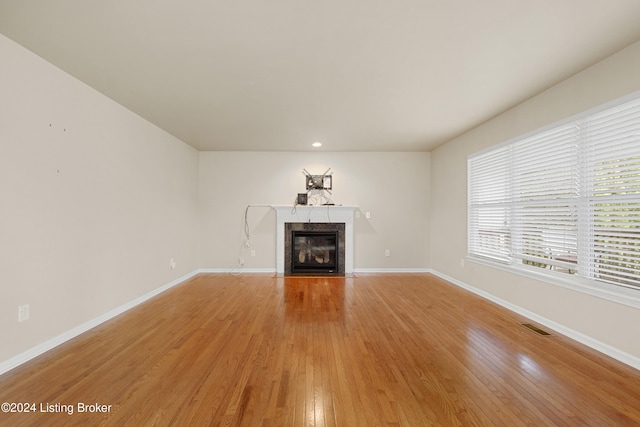 unfurnished living room with light hardwood / wood-style flooring