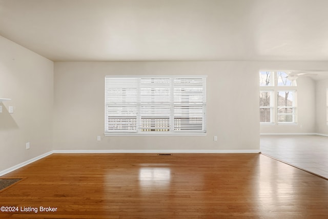 empty room featuring wood-type flooring and ceiling fan