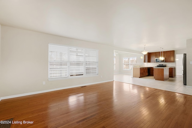 unfurnished living room with light hardwood / wood-style flooring