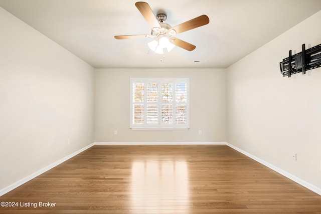 empty room featuring hardwood / wood-style flooring and ceiling fan