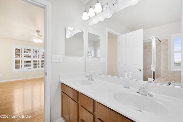 bathroom with ceiling fan, a shower with door, vanity, and hardwood / wood-style flooring