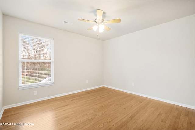 empty room featuring ceiling fan and light wood-type flooring