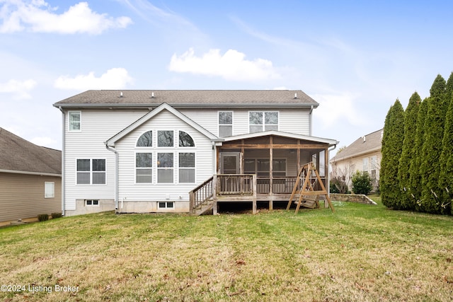 rear view of property with a sunroom and a yard