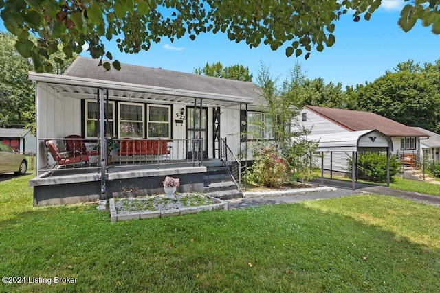 view of front of home with a carport, covered porch, and a front yard