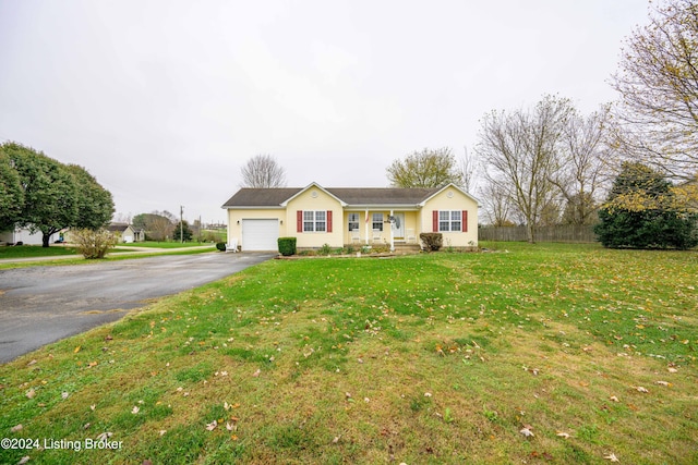 single story home with a porch, a garage, and a front lawn