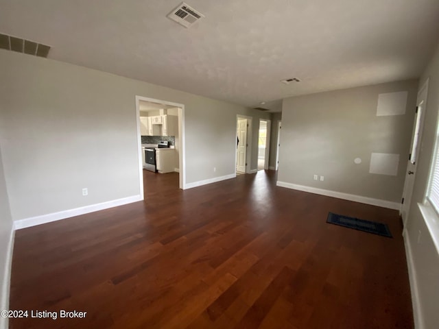 empty room featuring dark hardwood / wood-style flooring