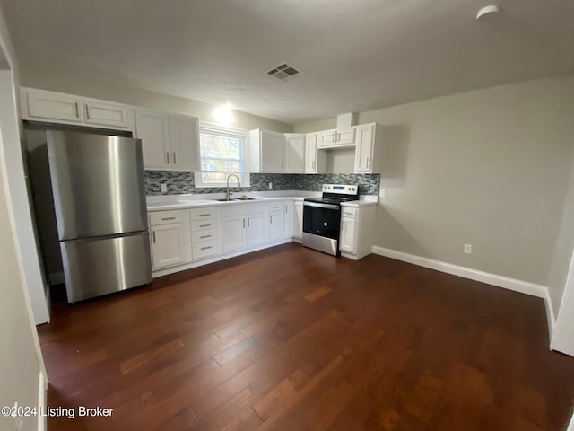 kitchen featuring dark hardwood / wood-style flooring, backsplash, stainless steel appliances, sink, and white cabinets