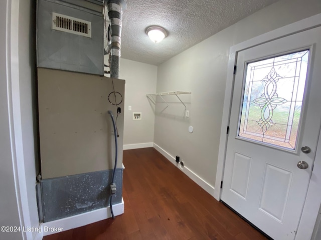 clothes washing area with a textured ceiling, heating unit, washer hookup, and dark hardwood / wood-style floors