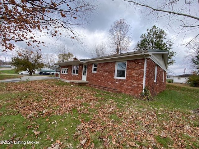 view of home's exterior with a lawn