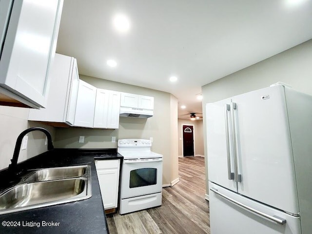 kitchen with sink, white cabinets, hardwood / wood-style floors, and white appliances