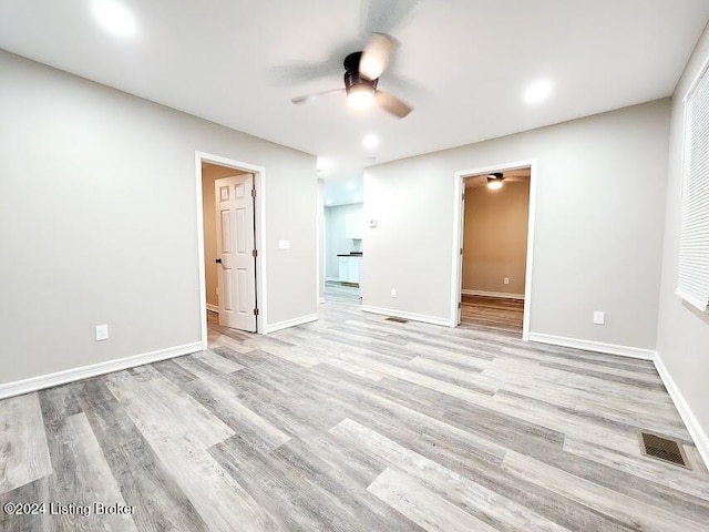 empty room featuring ceiling fan and light hardwood / wood-style flooring