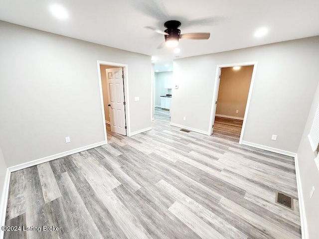 empty room featuring ceiling fan and light hardwood / wood-style flooring