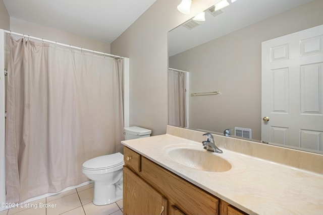 bathroom with tile patterned floors, vanity, and toilet