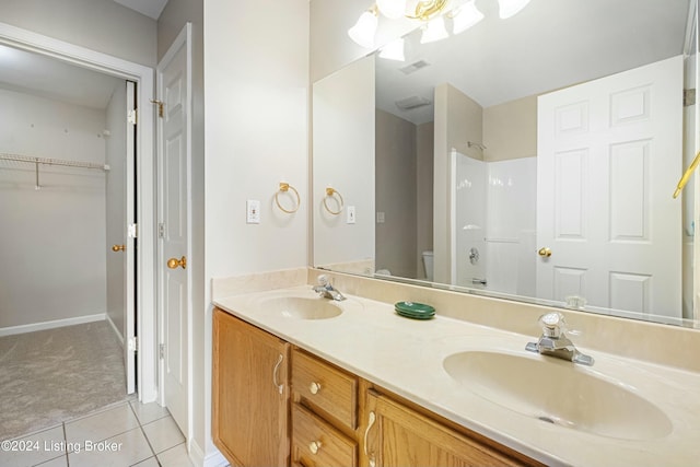 bathroom featuring tile patterned floors, a shower, vanity, and toilet