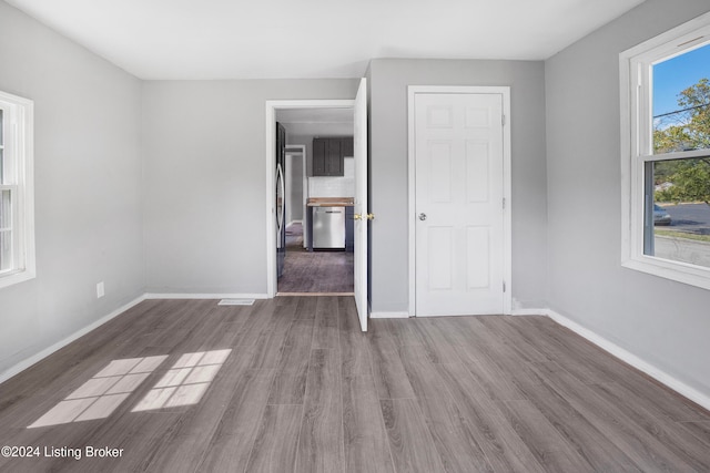 unfurnished bedroom with dark hardwood / wood-style flooring