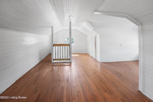 additional living space featuring hardwood / wood-style floors and vaulted ceiling