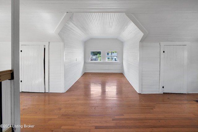 bonus room featuring wood-type flooring and vaulted ceiling