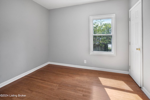 empty room with hardwood / wood-style flooring