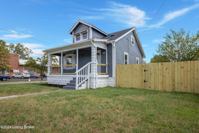 bungalow-style house featuring a porch and a front lawn