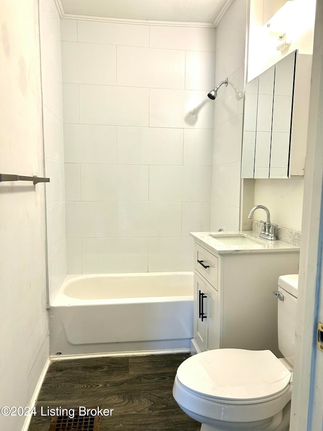 full bathroom featuring vanity, wood-type flooring, tiled shower / bath combo, and toilet