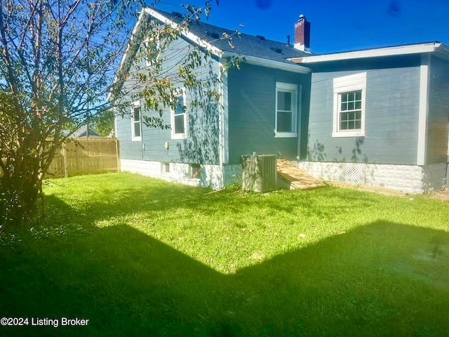 view of side of home with a lawn