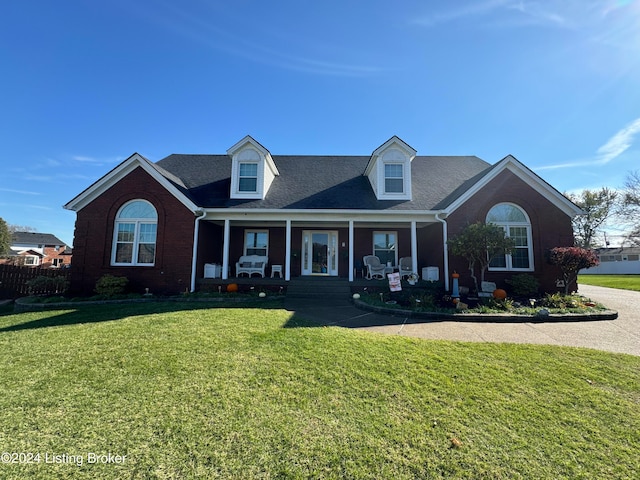 new england style home with a front yard and a porch