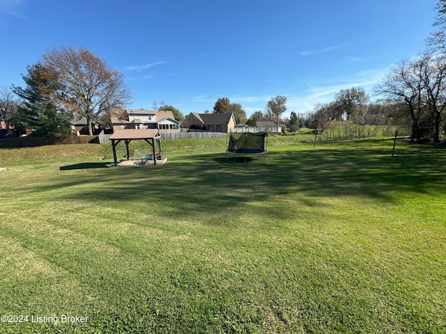 view of yard featuring a gazebo and a trampoline