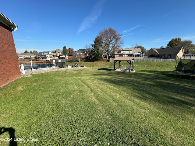 view of yard with a gazebo and a trampoline