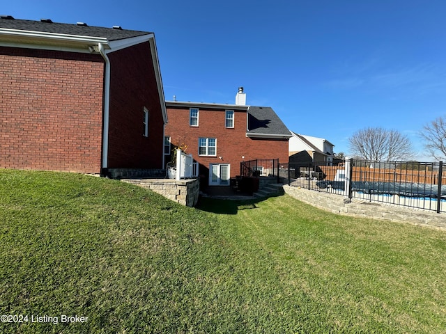 rear view of house with a yard