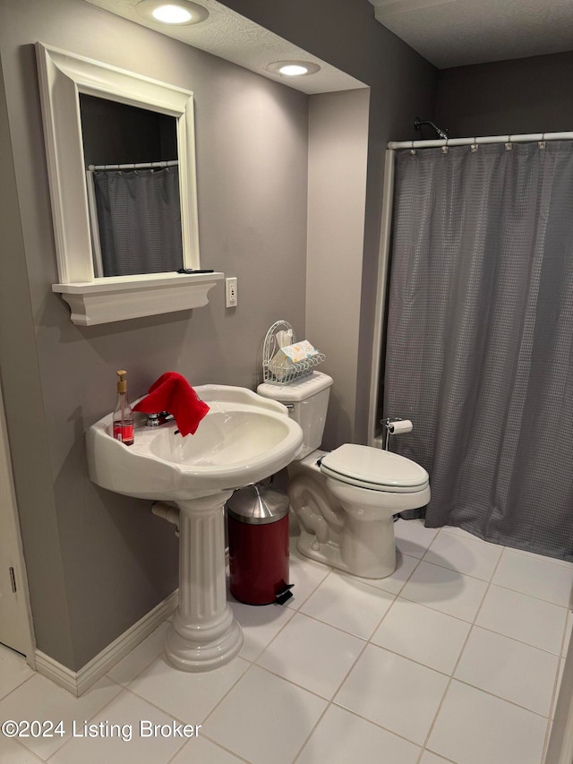 bathroom featuring tile patterned floors, a shower with curtain, and toilet