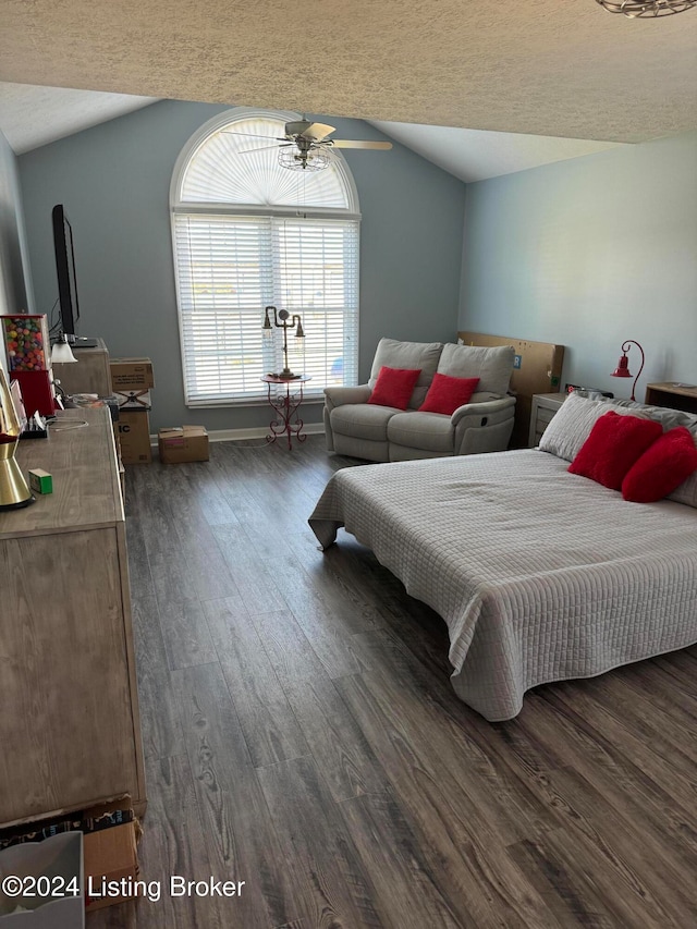 bedroom featuring ceiling fan, dark hardwood / wood-style flooring, lofted ceiling, and a textured ceiling