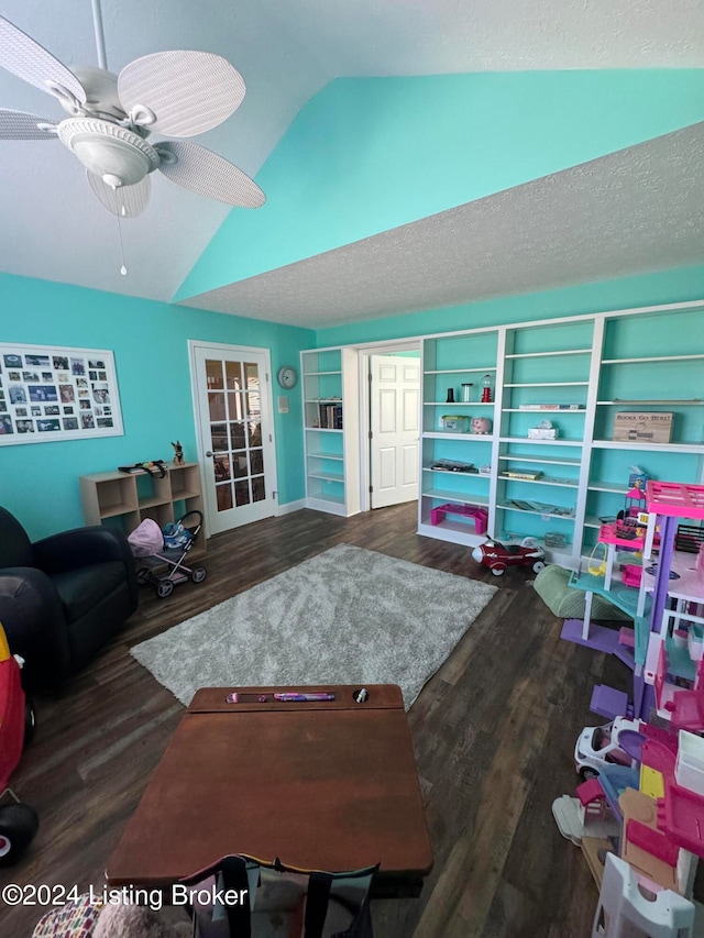 living room with dark hardwood / wood-style floors, ceiling fan, and vaulted ceiling