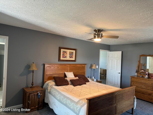 carpeted bedroom featuring a textured ceiling and ceiling fan