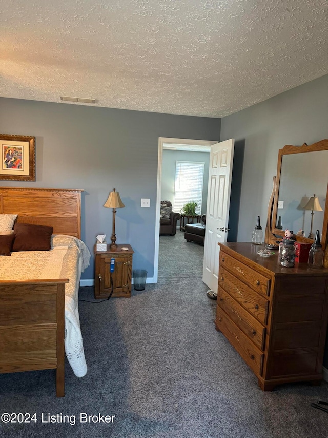 carpeted bedroom with a textured ceiling