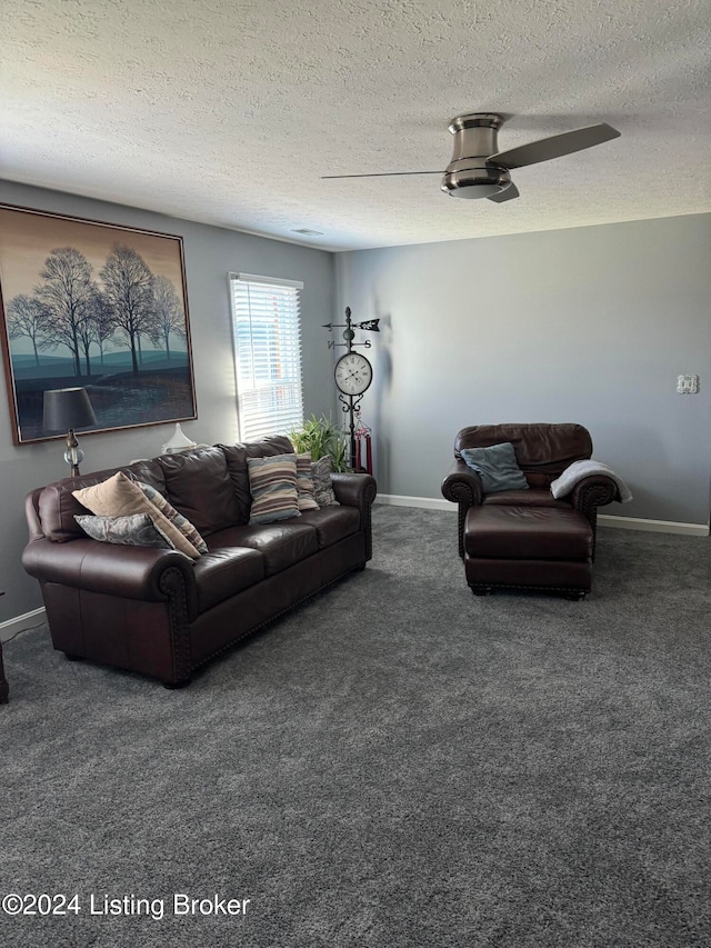 living room featuring dark colored carpet, ceiling fan, and a textured ceiling