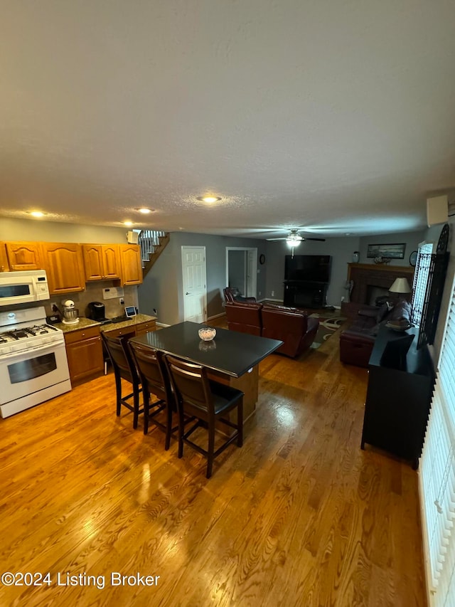 dining space featuring ceiling fan and light hardwood / wood-style floors