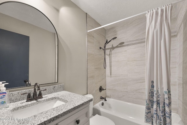 full bathroom with vanity, toilet, shower / bath combo, and a textured ceiling