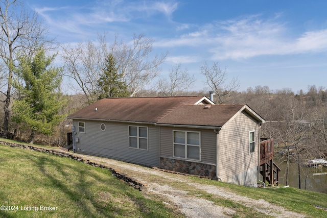 view of side of home with a yard