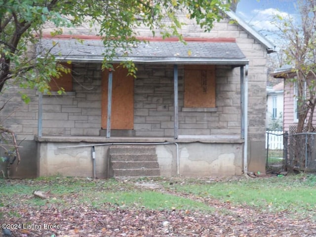 view of side of property with a porch